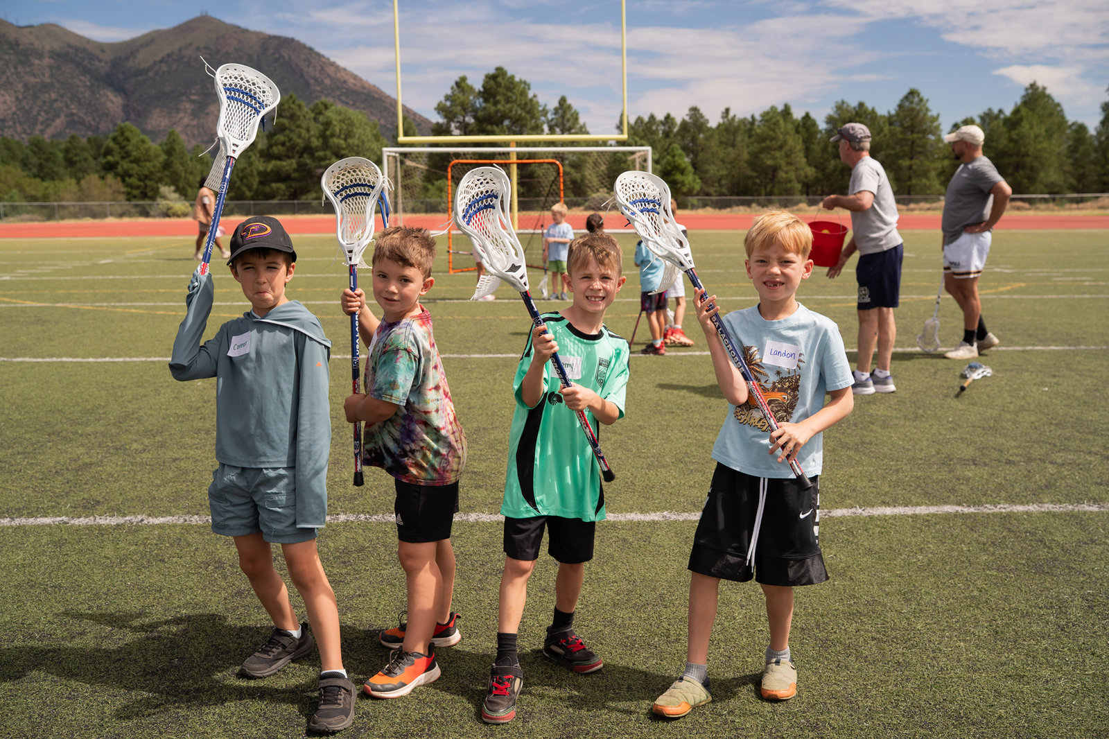 Young players holding lacrosse sticks at a Northern Arizona Youth Lacrosse clinic in Flagstaff