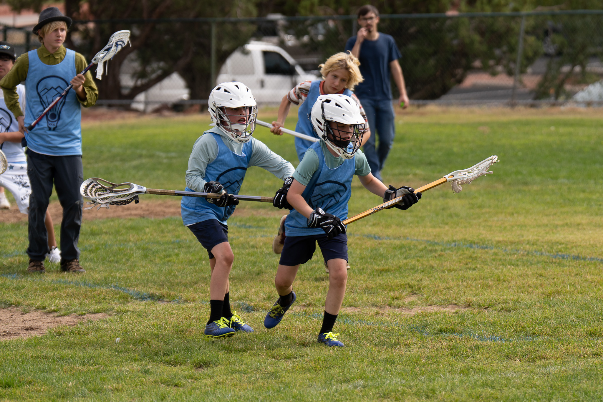 Young NAYL players in blue jerseys running with lacrosse sticks during the September Play Day in Sedona